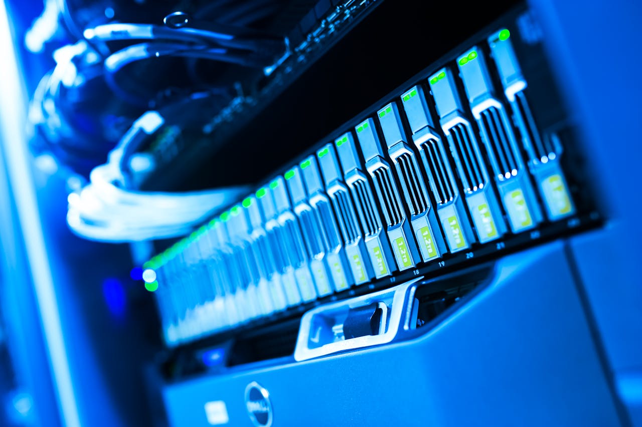 contact-img A detailed view of a blue lit computer server rack in a data center showcasing technology and hardware.